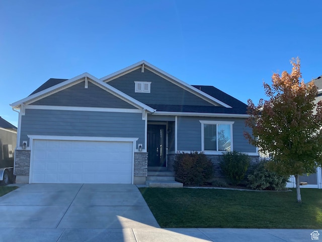 63 N Canyon Maple Rd, Vineyard, UT 84059 - craftsman-style home featuring a front lawn, stone siding, driveway, and a garage