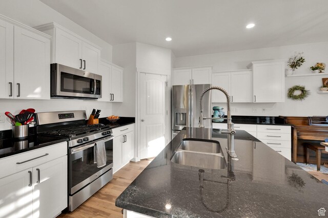 1752 S 570 W, Provo, UT 84601 - kitchen with appliances with stainless steel finishes, white cabinetry, recessed lighting, light wood-type flooring, and dark stone counters