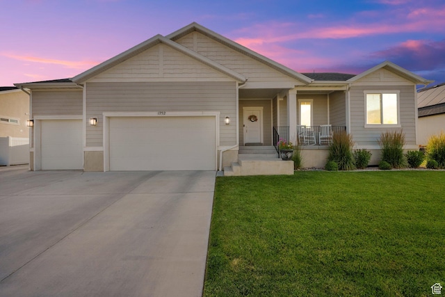 1752 S 570 W, Provo, UT 84601 - ranch-style house with an attached garage, a porch, a front yard, and driveway