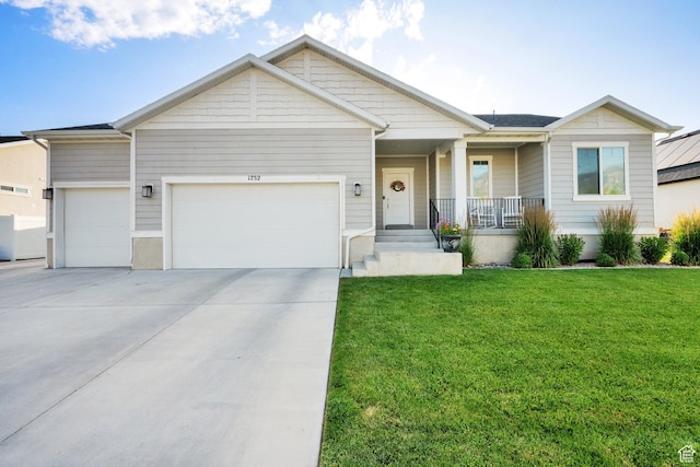 1752 S 570 W, Provo, UT 84601 - view of front of property featuring a garage, covered porch, a front yard, and concrete driveway