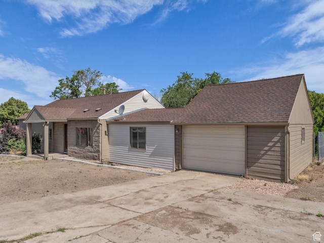 161 E 200 S, Tooele, UT 84074 - view of front of property featuring a garage, driveway, roof with shingles, and stone siding