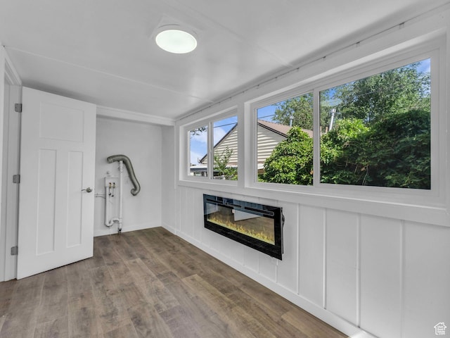 161 E 200 S, Tooele, UT 84074 - unfurnished living room featuring a glass covered fireplace and wood finished floors