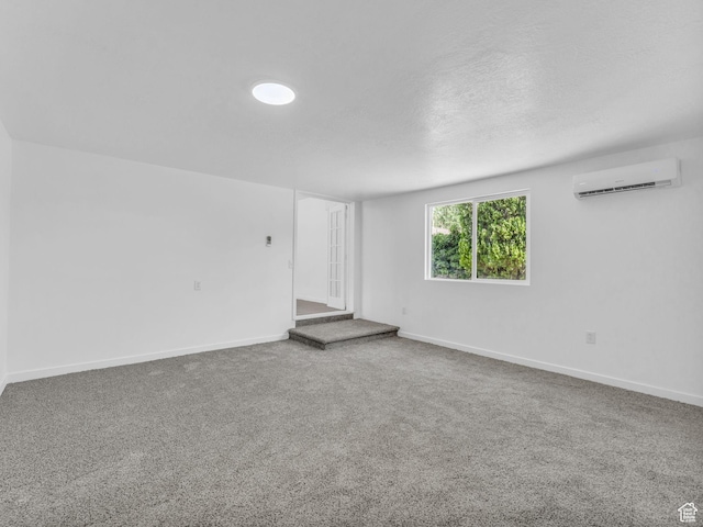 161 E 200 S, Tooele, UT 84074 - carpeted empty room featuring a wall mounted AC and a textured ceiling