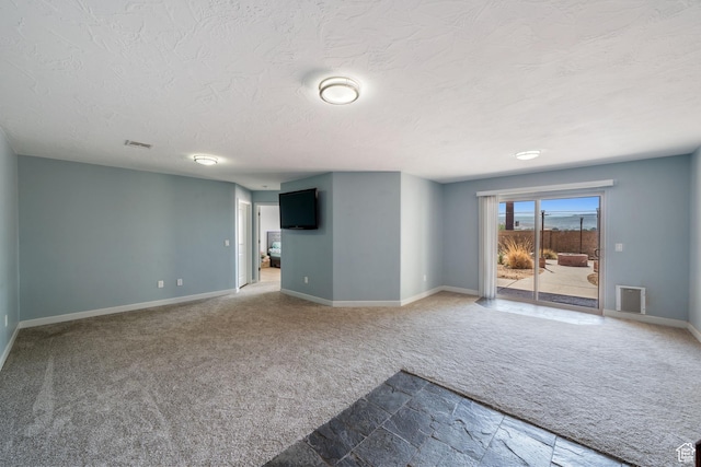 2752 E 50 S, St George, UT 84790 - unfurnished living room with carpet flooring, a textured ceiling, and stone finish flooring