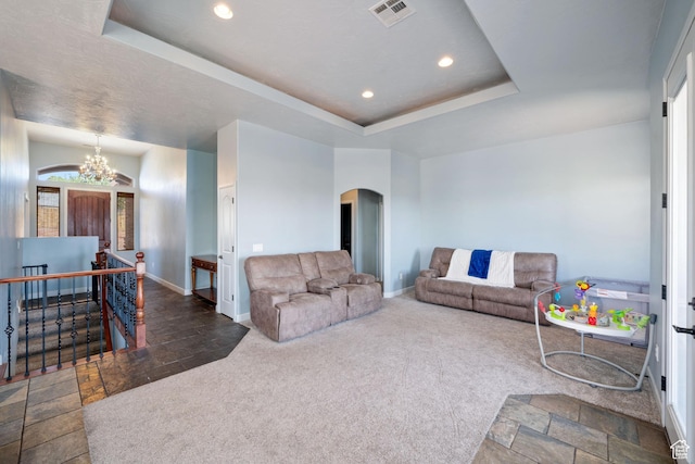 2752 E 50 S, St George, UT 84790 - carpeted living room with arched walkways, stone tile floors, a raised ceiling, recessed lighting, and a chandelier