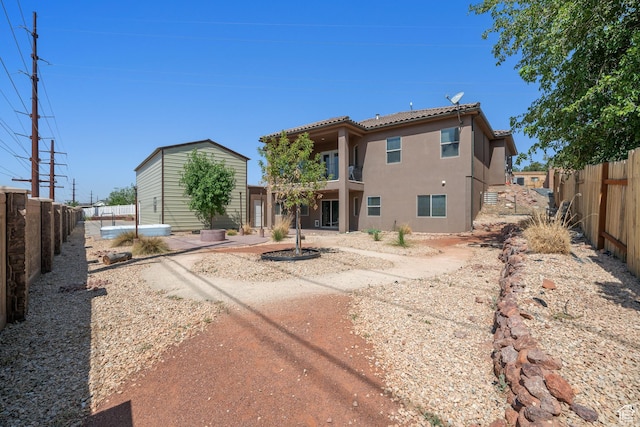2752 E 50 S, St George, UT 84790 - rear view of house with stucco siding, a fenced backyard, and a tile roof