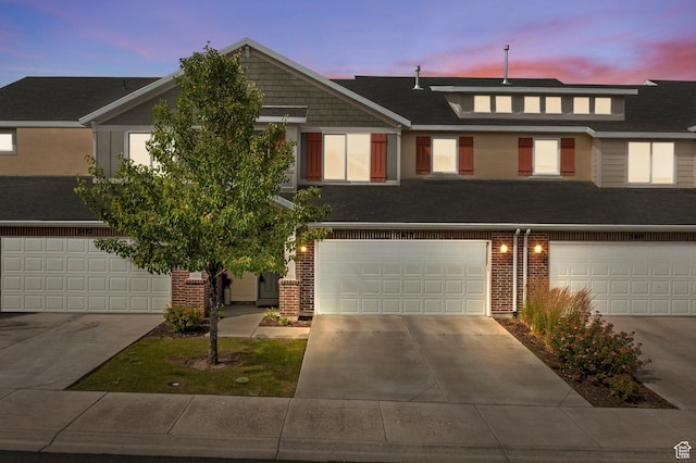 5423 W Black Hills Ln, Herriman, UT 84096 - townhome / multi-family property with a garage, concrete driveway, and brick siding