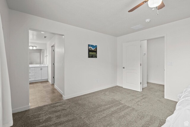 5423 W Black Hills Ln, Herriman, UT 84096 - unfurnished bedroom featuring carpet floors, ensuite bathroom, and a ceiling fan