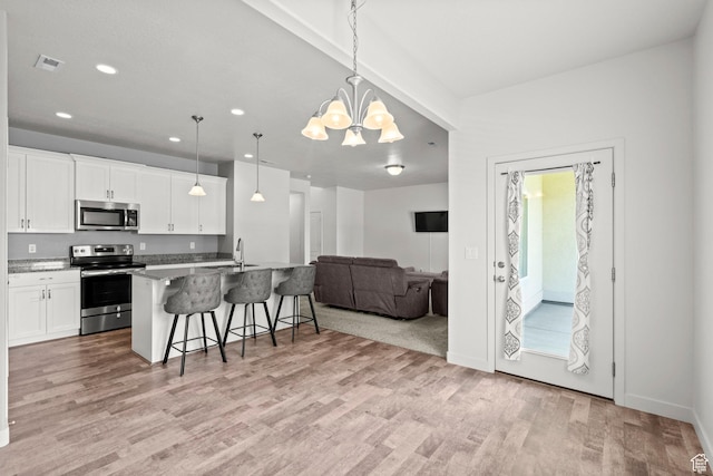 5423 W Black Hills Ln, Herriman, UT 84096 - kitchen featuring stainless steel appliances, a kitchen bar, light wood finished floors, open floor plan, and white cabinetry