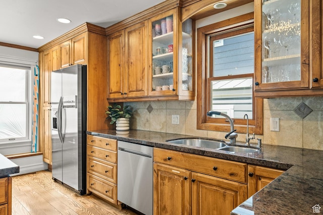 915 Norfolk Ave, Park City, UT 84060 - kitchen with appliances with stainless steel finishes, brown cabinetry, light wood-style flooring, backsplash, and crown molding