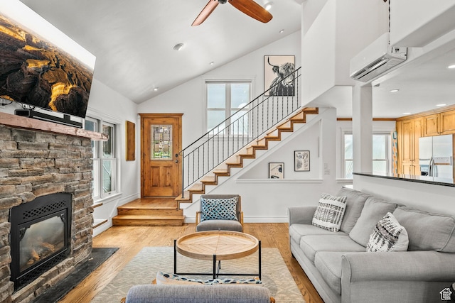 915 Norfolk Ave, Park City, UT 84060 - living room featuring a wall mounted AC, stairs, light wood finished floors, healthy amount of natural light, and high vaulted ceiling