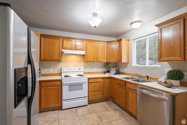 10 S 1000 E, Payson, UT 84651 - kitchen with stainless steel appliances, under cabinet range hood, light countertops, light tile patterned floors, and brown cabinets