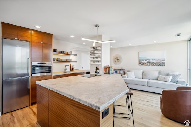 777 E S Temple Unit 13B, Salt Lake City, UT 84102 - kitchen with stainless steel appliances, light wood-style floors, modern cabinets, a center island, and recessed lighting