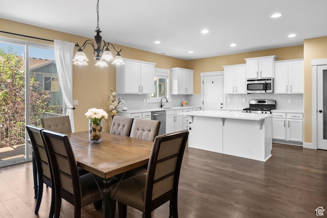 5194 Hedgerose Dr, Herriman, UT 84096 - dining area featuring a chandelier, dark wood finished floors, and recessed lighting