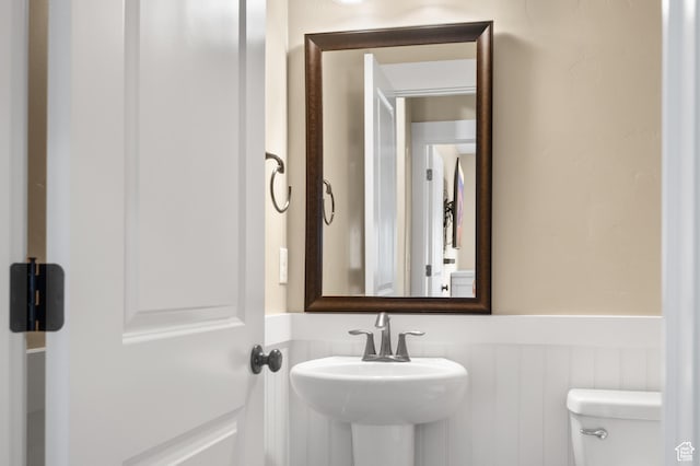 5194 Hedgerose Dr, Herriman, UT 84096 - half bath featuring toilet and wainscoting