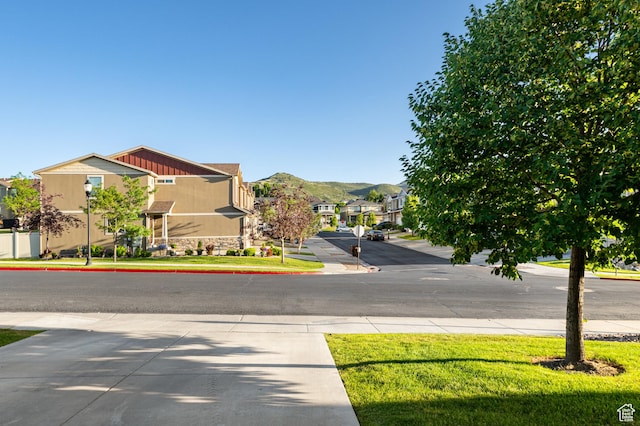 5194 Hedgerose Dr, Herriman, UT 84096 - view of road featuring a residential view, street lighting, sidewalks, and a mountain view