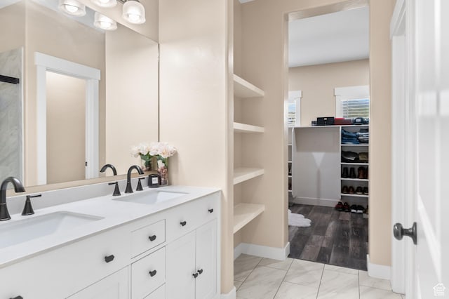 5194 Hedgerose Dr, Herriman, UT 84096 - bathroom featuring double vanity, a walk in closet, and marble finish flooring