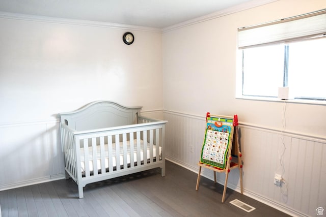 729 W 2300 N, Harrisville, UT 84414 - bedroom featuring wood finished floors, wainscoting, a nursery area, and ornamental molding