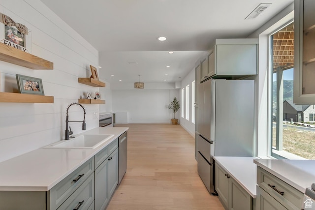 481 E 3675 N, North Ogden, UT 84414 - kitchen with open shelves, freestanding refrigerator, stainless steel dishwasher, light wood-type flooring, and gray cabinetry