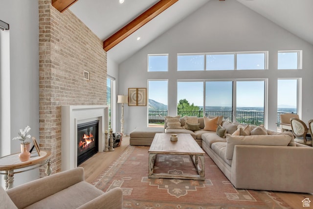 481 E 3675 N, North Ogden, UT 84414 - living room with high vaulted ceiling, a brick fireplace, wood finished floors, beamed ceiling, and recessed lighting