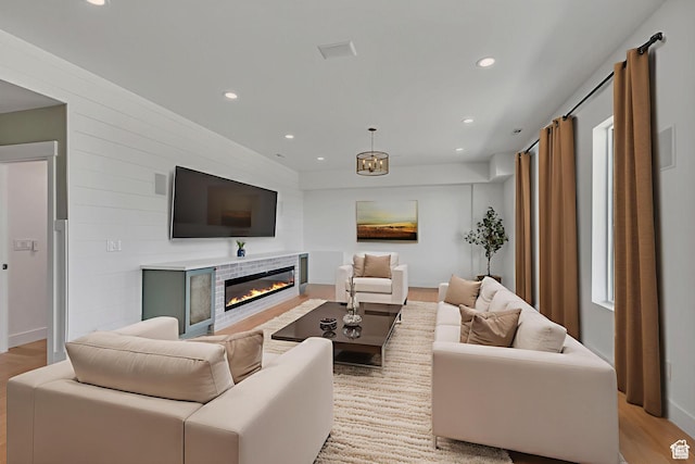 481 E 3675 N, North Ogden, UT 84414 - living room featuring light wood-style floors, a glass covered fireplace, and recessed lighting