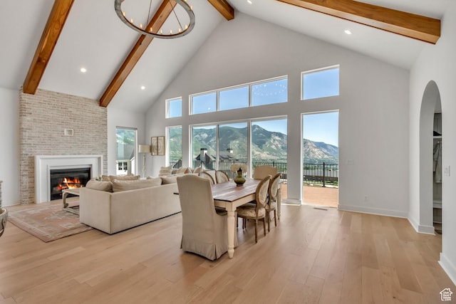 481 E 3675 N, North Ogden, UT 84414 - living room with high vaulted ceiling, beamed ceiling, a mountain view, wood finished floors, and a fireplace