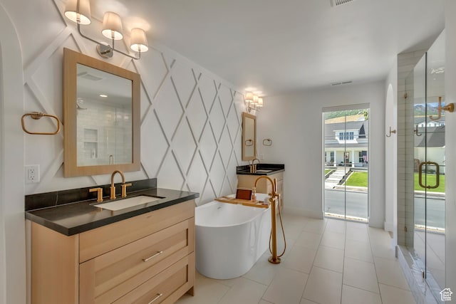 481 E 3675 N, North Ogden, UT 84414 - bathroom with two vanities, a freestanding tub, a shower stall, and tile patterned floors