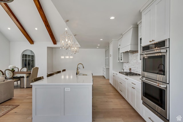 481 E 3675 N, North Ogden, UT 84414 - kitchen featuring appliances with stainless steel finishes, decorative backsplash, white cabinets, recessed lighting, and a chandelier