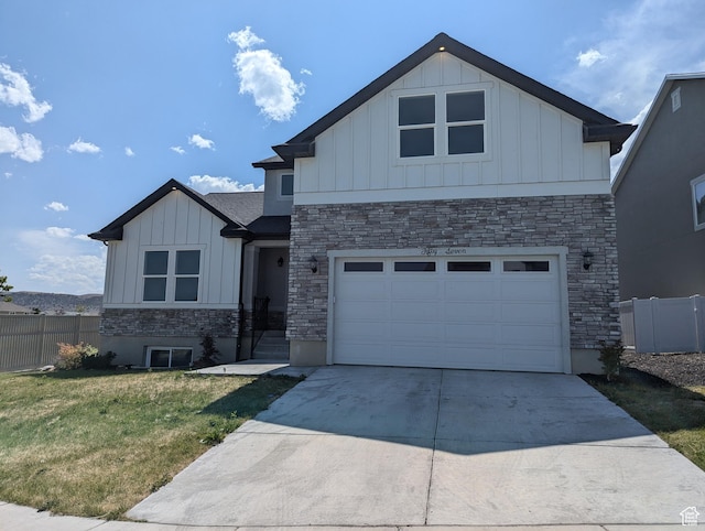 57 N Midland Dr, Saratoga Springs, UT 84045 - view of front of property featuring board and batten siding, driveway, and stone siding