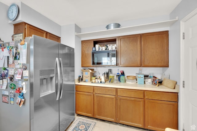 11901 S Maple Ridge Rd, Sandy, UT 84094 - kitchen with stainless steel fridge with ice dispenser, black microwave, light countertops, and brown cabinetry