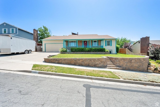 11901 S Maple Ridge Rd, Sandy, UT 84094 - ranch-style home with concrete driveway, a garage, and covered porch
