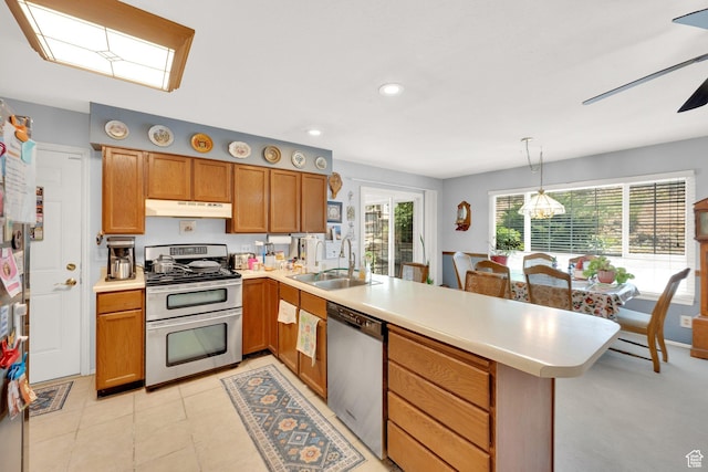 11901 S Maple Ridge Rd, Sandy, UT 84094 - kitchen featuring stainless steel appliances, under cabinet range hood, a peninsula, light countertops, and recessed lighting