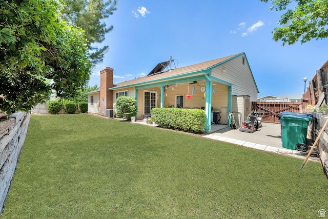 11901 S Maple Ridge Rd, Sandy, UT 84094 - back of property with a ceiling fan, a patio area, a fenced backyard, and a chimney