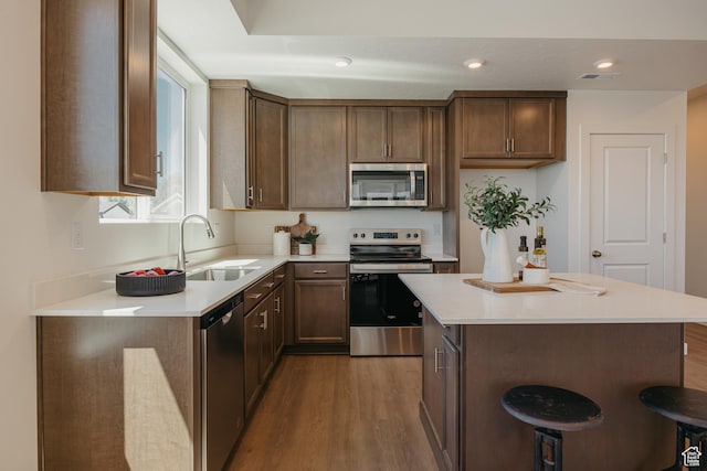 247 E 1825 N Unit 12, North Ogden, UT 84414 - kitchen featuring appliances with stainless steel finishes, wood finished floors, light countertops, a center island, and recessed lighting