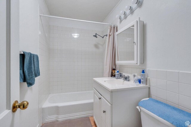 657 N 1100 E, Provo, UT 84606 - bathroom featuring vanity, shower / bath combo with shower curtain, and tile walls