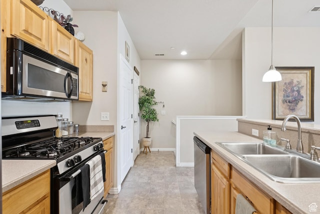 1676 E 1080 S, Provo, UT 84604 - kitchen with appliances with stainless steel finishes, light brown cabinetry, recessed lighting, light countertops, and decorative light fixtures