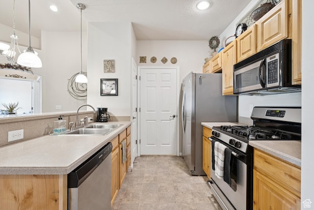 1676 E 1080 S, Provo, UT 84604 - kitchen with appliances with stainless steel finishes, light brown cabinetry, a peninsula, light countertops, and hanging light fixtures