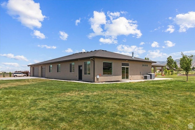 1145 W 500 N, Manti, UT 84642 - rear view of house with concrete driveway, a lawn, stucco siding, and an attached garage