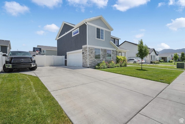 969 S 875 W, Springville, UT 84663 - traditional home with stone siding, concrete driveway, an attached garage, stucco siding, and a residential view