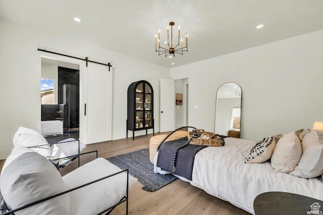 1565 E Centaurus Way Unit 108, Washington, UT 84780 - bedroom with a barn door, a chandelier, wood finished floors, and recessed lighting