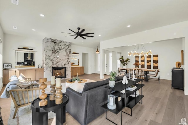 1565 E Centaurus Way Unit 108, Washington, UT 84780 - living room with a high end fireplace, recessed lighting, a chandelier, ceiling fan, and light wood-style floors
