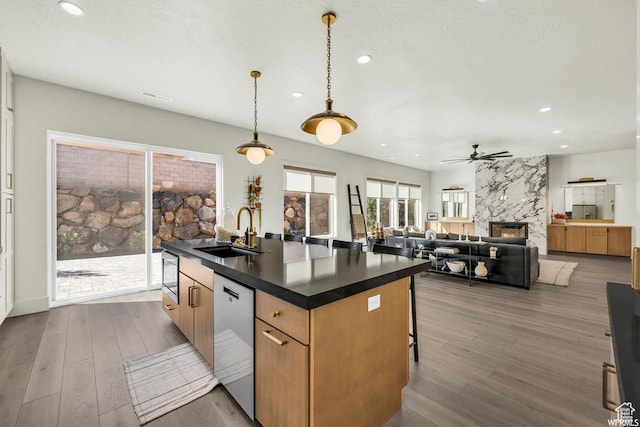 1565 E Centaurus Way Unit 108, Washington, UT 84780 - kitchen featuring stainless steel dishwasher, dark countertops, recessed lighting, ceiling fan, and a premium fireplace
