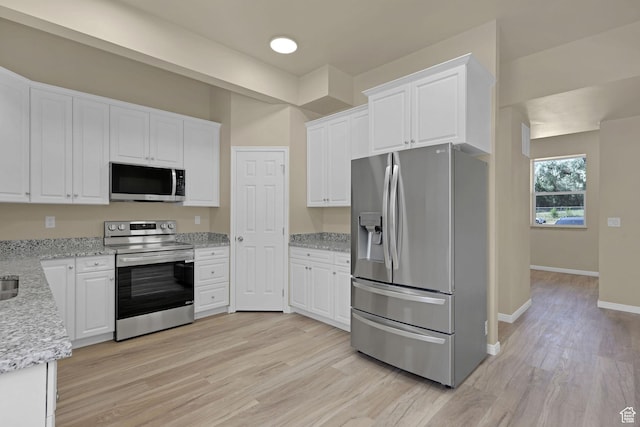 454 E 850 S Unit 106, Brigham City, UT 84302 - kitchen featuring appliances with stainless steel finishes, white cabinets, and light wood finished floors