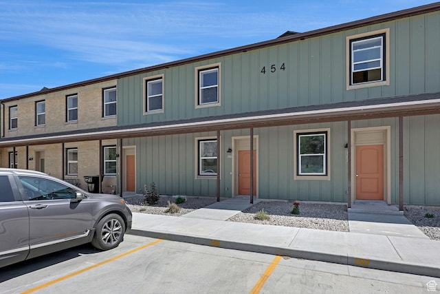 454 E 850 S Unit 106, Brigham City, UT 84302 - view of property featuring board and batten siding, uncovered parking, and a porch