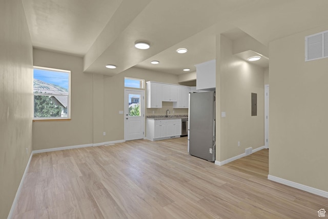454 E 850 S Unit 106, Brigham City, UT 84302 - unfurnished living room featuring plenty of natural light, light wood finished floors, recessed lighting, and electric panel
