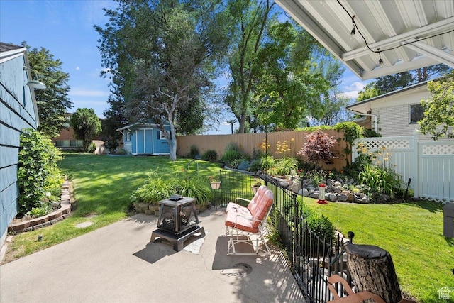 5203 Chambers St, South Ogden, UT 84403 - fenced backyard with a patio and a storage unit