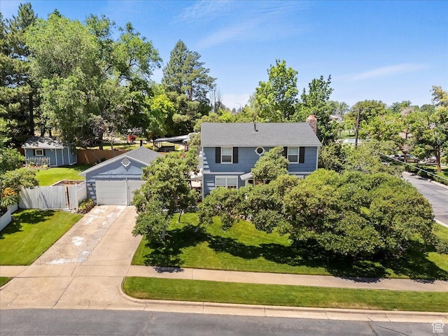 5203 Chambers St, South Ogden, UT 84403 - view of front of property with concrete driveway, a chimney, and view of wooded area
