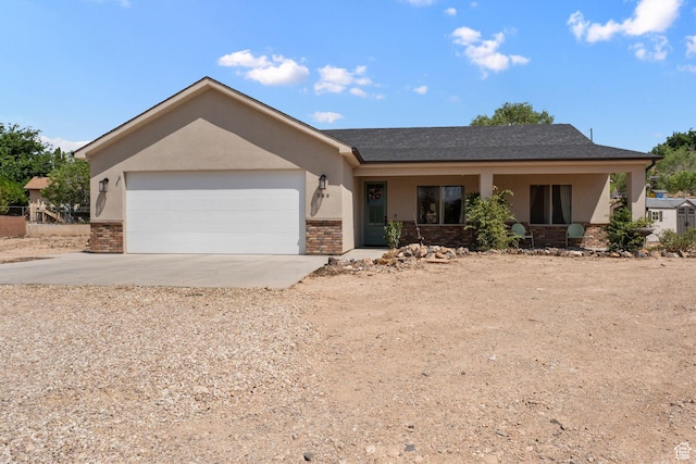 586 N 360 W, La Verkin, UT 84745 - ranch-style house with stucco siding, driveway, a garage, brick siding, and covered porch
