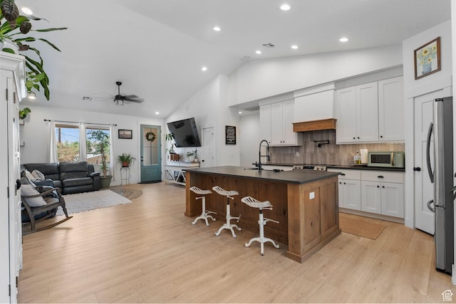 586 N 360 W, La Verkin, UT 84745 - kitchen with dark countertops, custom exhaust hood, open floor plan, freestanding refrigerator, and recessed lighting