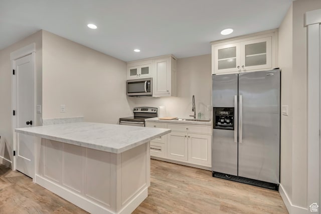 2040 E Lambourne Ave, Millcreek, UT 84109 - kitchen featuring stainless steel appliances, light wood finished floors, glass insert cabinets, recessed lighting, and white cabinetry